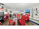 Open-concept living room with glass dining table, fireplace, and waterfront view at 521 Marina Point Dr # 521, Daytona Beach, FL 32114