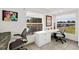 Office with multiple windows, built-in desk, and modern decor at 521 Marina Point Dr # 521, Daytona Beach, FL 32114