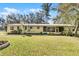 Residential home has a well-manicured lawn and charming yellow siding at 53722 Rivertrace Rd, Astor, FL 32102