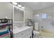 Bathroom features a shower-tub combo, a framed mirror and white vanity at 53722 Rivertrace Rd, Astor, FL 32102