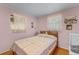 Comfortable bedroom featuring twin windows, hardwood floors and a teddy bear at 53722 Rivertrace Rd, Astor, FL 32102