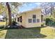 Residential home boasts a well-manicured lawn and yellow siding at 53722 Rivertrace Rd, Astor, FL 32102