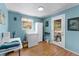 Bright laundry room with blue walls and white appliances, providing a functional space at 53722 Rivertrace Rd, Astor, FL 32102