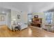 Bright living room with wood flooring, a decorative fireplace, and large windows bringing in natural light at 53722 Rivertrace Rd, Astor, FL 32102
