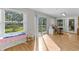 Bright and airy living space with wood floors, large windows, and a sliding glass door leading to the outside at 53722 Rivertrace Rd, Astor, FL 32102