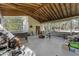 Large screened in porch with many windows and a fire pit at 53722 Rivertrace Rd, Astor, FL 32102