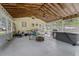Large screened porch with a ceiling fan, fire pit and multiple access points at 53722 Rivertrace Rd, Astor, FL 32102