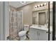Bathroom featuring a shower with curtain, a toilet, and a vanity with mirror and lighting at 605 Anderson Dr, Deltona, FL 32725