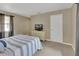 Cozy bedroom featuring a striped bedspread, dresser with tv, and ample natural light at 605 Anderson Dr, Deltona, FL 32725
