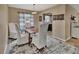 Bright dining room with wood table, slip-covered chairs, light fixture and view to kitchen at 605 Anderson Dr, Deltona, FL 32725