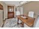 Dining room with wood table, slip-covered chairs, and decorative china cabinet at 605 Anderson Dr, Deltona, FL 32725