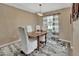 Cozy dining room featuring a rustic table, slip-covered chairs, and decorative chandelier at 605 Anderson Dr, Deltona, FL 32725