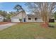Charming single-story home with a manicured lawn and inviting blue front door at 605 Anderson Dr, Deltona, FL 32725