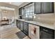 Efficient kitchen with granite countertops, dark cabinets, and stainless steel dishwasher at 605 Anderson Dr, Deltona, FL 32725