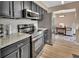 Modern kitchen with stainless appliances, granite counters, and a view into the dining area at 605 Anderson Dr, Deltona, FL 32725