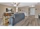 Comfortable living room with a modern gray sofa, ceiling fan, and stylish decor at 605 Anderson Dr, Deltona, FL 32725