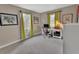 Home office with dual windows, desk, chair, art and neutral carpet at 605 Anderson Dr, Deltona, FL 32725