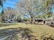 A large backyard with grass, a fire pit, an RV, and a storage shed at 61 West Highbanks, Debary, FL 32713