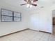 A bright bedroom featuring neutral tile flooring, a ceiling fan, and closet doors at 61 West Highbanks, Debary, FL 32713