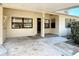 Close up view of covered entry porch and carport with concrete flooring and brick accents at 61 West Highbanks, Debary, FL 32713