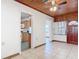 Living room featuring tile flooring, wooden ceiling, and entrance to kitchen area at 61 West Highbanks, Debary, FL 32713