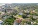 Aerial view of the home in a tree-lined neighborhood near the coast at 65 Calumet Ave, Ponce Inlet, FL 32127