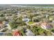 Aerial view of the home in a tree-lined neighborhood at 65 Calumet Ave, Ponce Inlet, FL 32127