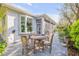 Back patio with a wooden dining set, large windows, and doors provide indoor-outdoor living at 65 Calumet Ave, Ponce Inlet, FL 32127