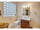 Elegant bathroom featuring a vanity with wood cabinets and modern fixtures, complemented by a glass block window at 65 Calumet Ave, Ponce Inlet, FL 32127