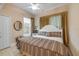A bedroom with a bed, a window, tile flooring, and a ceiling fan at 65 Calumet Ave, Ponce Inlet, FL 32127