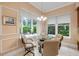 Breakfast nook features a glass table, seating for four, and many large windows at 65 Calumet Ave, Ponce Inlet, FL 32127