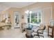 Bright breakfast nook features a large window, charming chandelier, and seating for four at 65 Calumet Ave, Ponce Inlet, FL 32127
