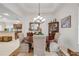 Well-lit dining room showcasing a round table, patterned chairs, and view into the adjacent kitchen at 65 Calumet Ave, Ponce Inlet, FL 32127