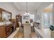 Elegant dining room with wood furniture, decorative mirror, and view of front entrance at 65 Calumet Ave, Ponce Inlet, FL 32127