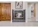 A beautiful tile fireplace in the bedroom has a gold frame and a decor burning inside at 65 Calumet Ave, Ponce Inlet, FL 32127