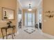 Inviting foyer with decorative front door and chandelier, showcasing the home's elegant entryway and design at 65 Calumet Ave, Ponce Inlet, FL 32127
