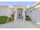 Welcoming front entrance with double doors, well-maintained landscaping, and classic exterior lighting fixtures at 65 Calumet Ave, Ponce Inlet, FL 32127