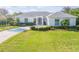 Beautiful one-story home with a well-manicured lawn and lovely landscaping, perfect for curb appeal at 65 Calumet Ave, Ponce Inlet, FL 32127