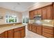 This kitchen features granite countertops and an eat-in bar area near a sun-drenched window at 65 Calumet Ave, Ponce Inlet, FL 32127