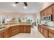 Spacious kitchen boasts granite counters, stainless appliances, and warm wood cabinetry at 65 Calumet Ave, Ponce Inlet, FL 32127