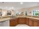 Open concept kitchen features stainless steel appliances and granite counters overlooking the living room at 65 Calumet Ave, Ponce Inlet, FL 32127