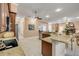 Open kitchen with stainless steel dishwasher, granite countertops, and direct view of the fireplace and living area at 65 Calumet Ave, Ponce Inlet, FL 32127