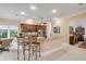 Bright kitchen with granite countertops, stainless steel appliances, and a casual breakfast bar seating area at 65 Calumet Ave, Ponce Inlet, FL 32127