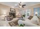 Cozy living room with fireplace, ceiling fan, and comfortable seating at 65 Calumet Ave, Ponce Inlet, FL 32127