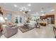 Open living room with ceiling fan, white tile floors, and adjacent kitchen area at 65 Calumet Ave, Ponce Inlet, FL 32127