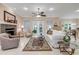Bright living room with fireplace, ceiling fan, neutral walls and decor, and access to outdoor area at 65 Calumet Ave, Ponce Inlet, FL 32127
