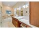 Bathroom with a large vanity, jacuzzi tub, and decorative tiling at 65 Calumet Ave, Ponce Inlet, FL 32127