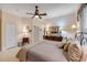 The main bedroom features a ceiling fan and a large dresser with an ornate mirror at 65 Calumet Ave, Ponce Inlet, FL 32127