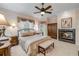 Spacious bedroom features a fireplace, a ceiling fan, and lots of natural light at 65 Calumet Ave, Ponce Inlet, FL 32127