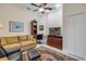 An office with tile flooring, leather chairs, a couch, a desk, and a TV at 65 Calumet Ave, Ponce Inlet, FL 32127